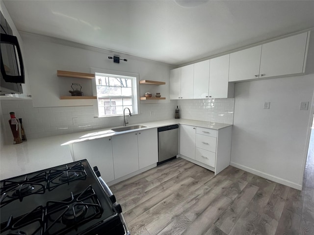 kitchen with white cabinetry, sink, dishwasher, black gas stove, and light wood-type flooring