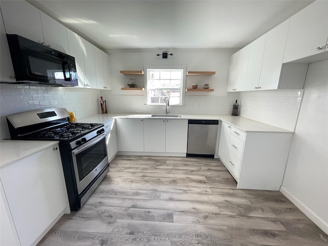 kitchen featuring sink, white cabinets, and stainless steel appliances