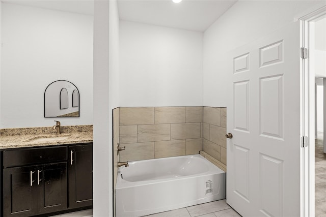 bathroom with tile patterned flooring, vanity, and a tub to relax in