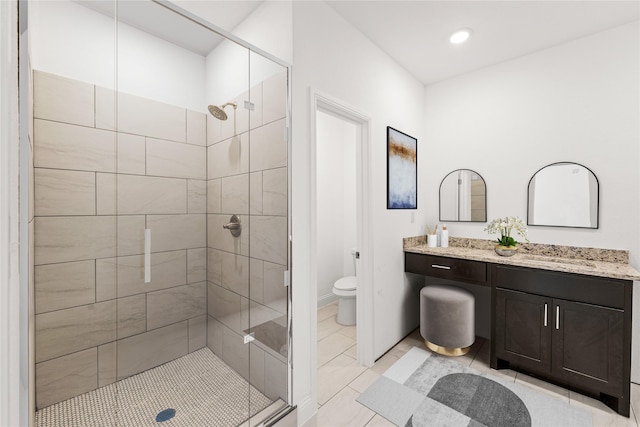 bathroom featuring tile patterned floors, vanity, toilet, and walk in shower