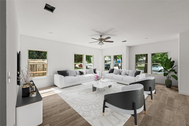 living room with light wood-type flooring and ceiling fan