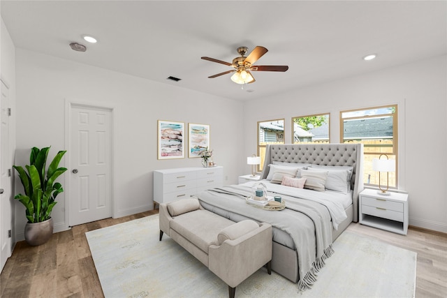 bedroom with ceiling fan and light wood-type flooring