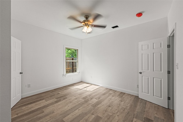 unfurnished room featuring hardwood / wood-style flooring and ceiling fan