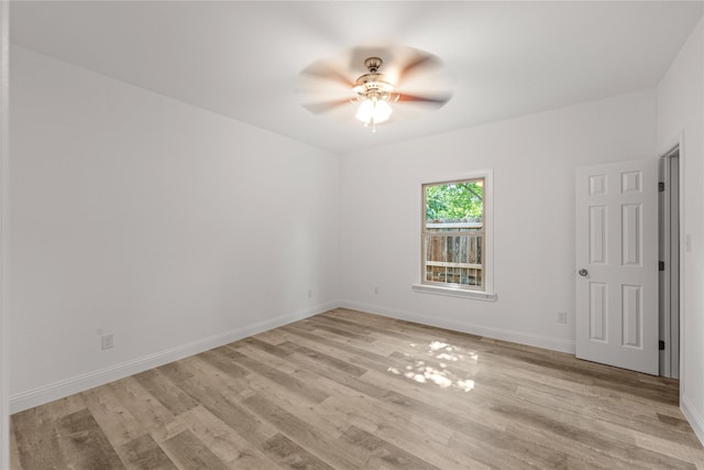 empty room featuring ceiling fan and light hardwood / wood-style floors