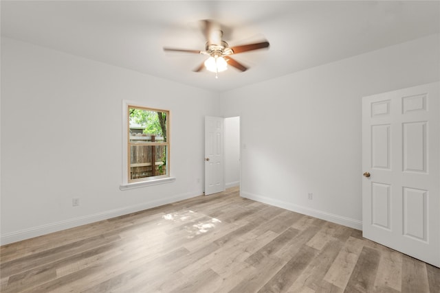 empty room featuring ceiling fan and light wood-type flooring