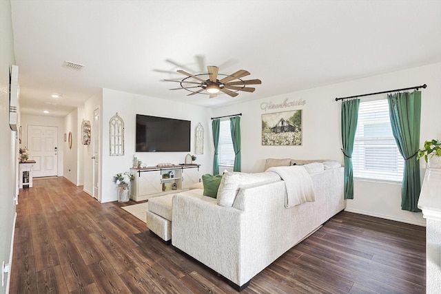 living room with ceiling fan and dark hardwood / wood-style flooring