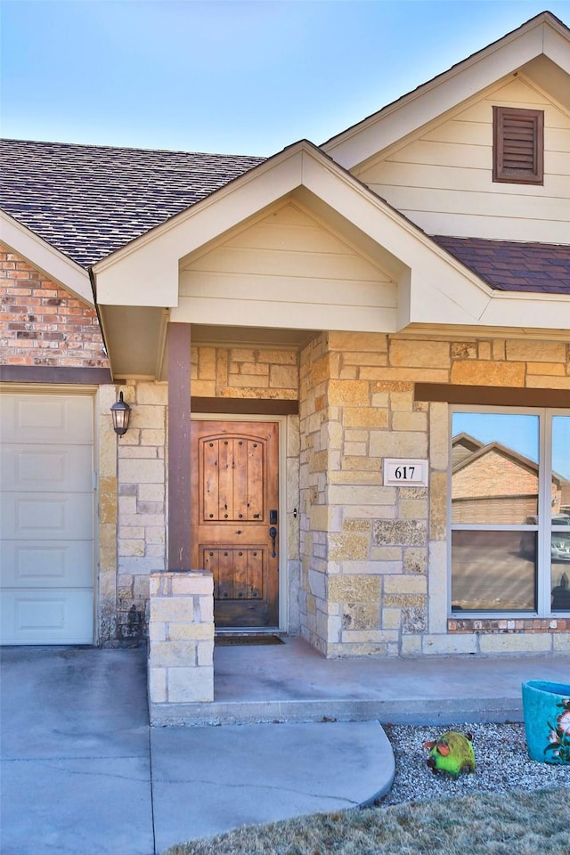 view of exterior entry with a garage