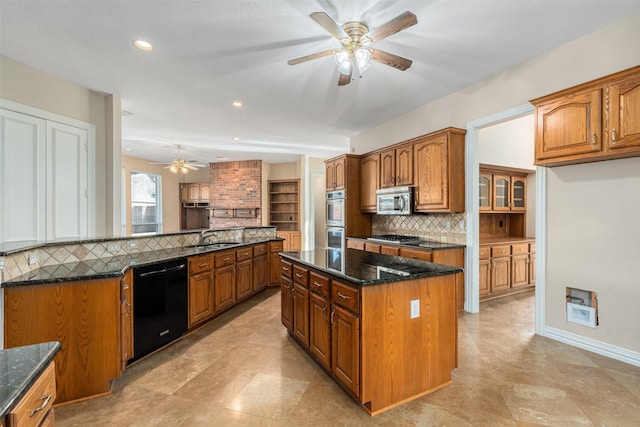 kitchen with a center island, stainless steel appliances, decorative backsplash, dark stone counters, and sink