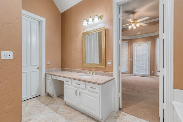 bathroom with vaulted ceiling, crown molding, tile patterned floors, vanity, and ceiling fan