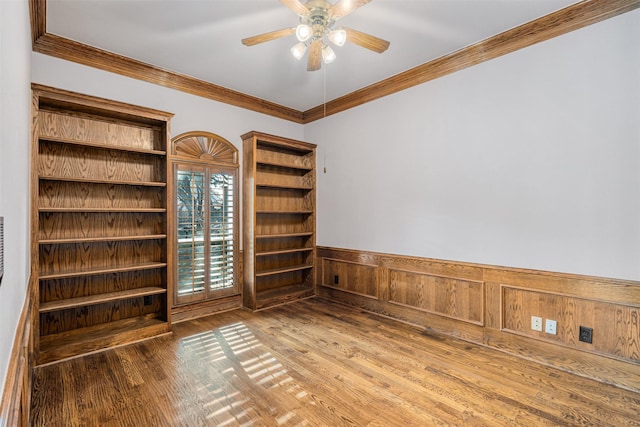 empty room featuring ceiling fan, ornamental molding, and hardwood / wood-style flooring