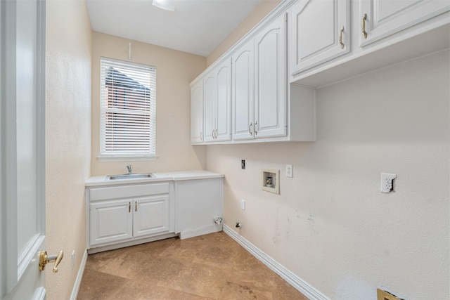 laundry area with gas dryer hookup, sink, hookup for a washing machine, and cabinets