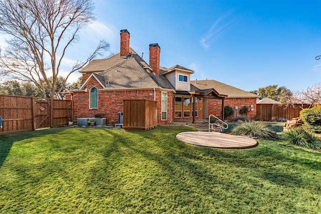 rear view of property featuring a patio and a lawn