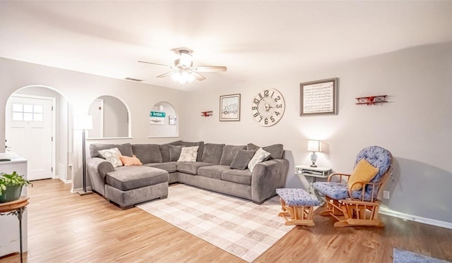 living room featuring light wood-type flooring and ceiling fan