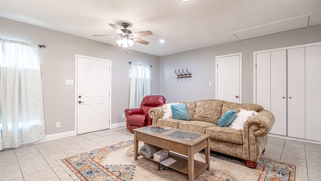 tiled living room with ceiling fan and a wealth of natural light