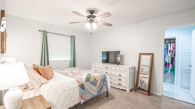 carpeted bedroom with a closet and ceiling fan