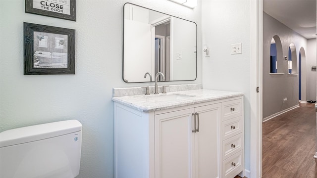 bathroom featuring hardwood / wood-style floors, toilet, and vanity