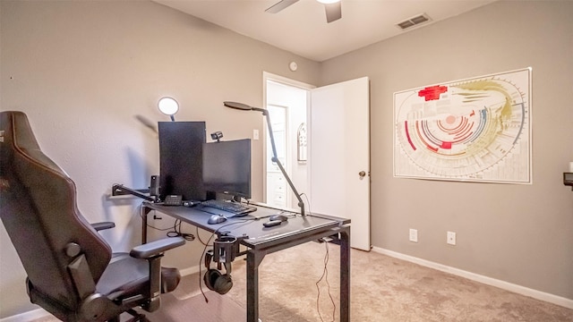 carpeted home office with ceiling fan