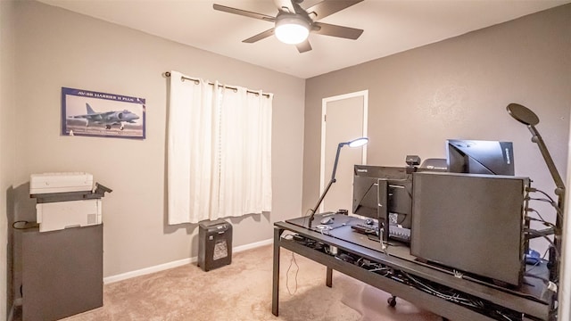 home office featuring light carpet and ceiling fan