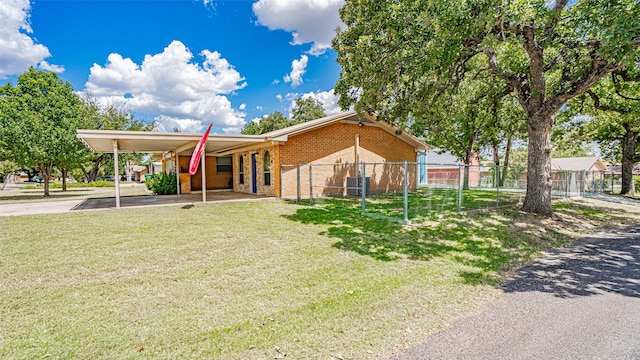 view of front of house featuring a front lawn and a carport