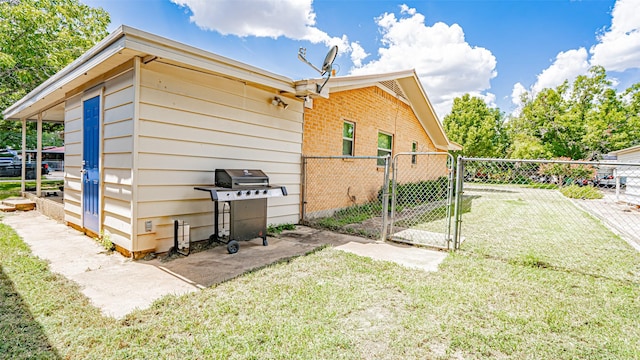 view of side of home with a yard