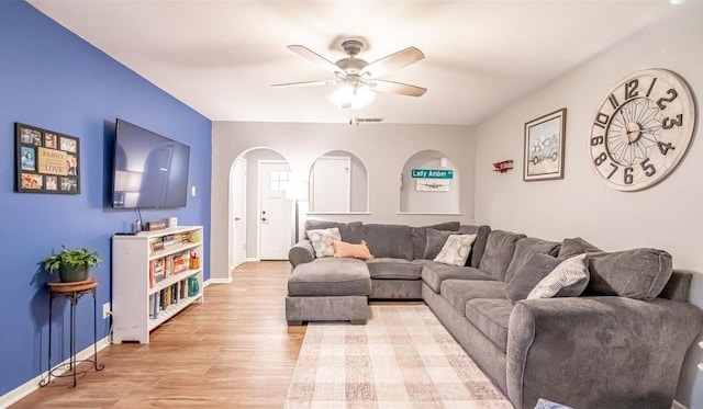 living room with ceiling fan and light wood-type flooring