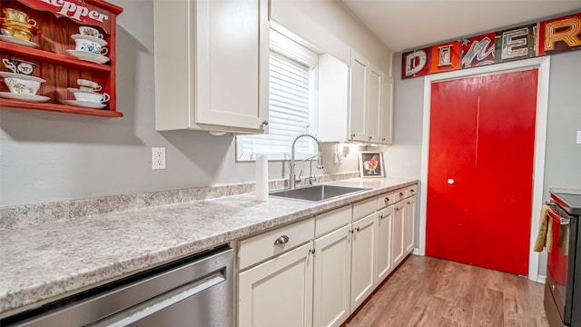 kitchen featuring light wood-type flooring, sink, stainless steel appliances, and white cabinetry