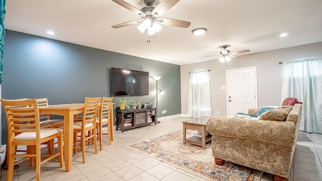 tiled living room with ceiling fan and a wealth of natural light