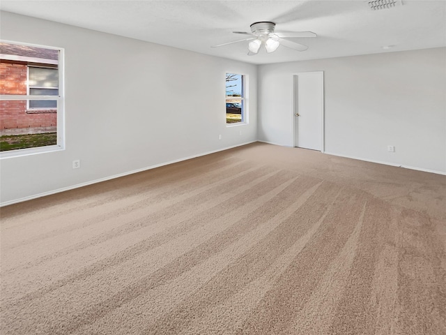 spare room with carpet floors and ceiling fan