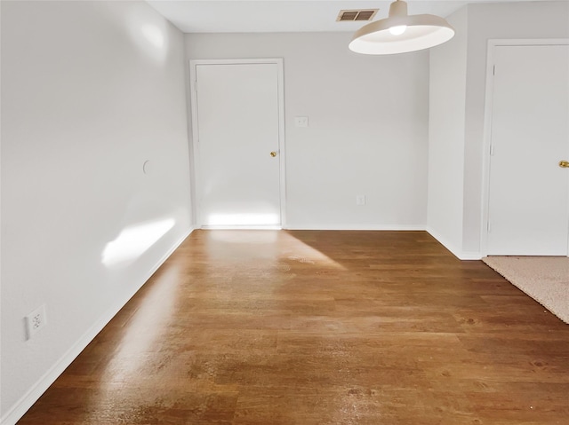 empty room with dark wood-type flooring