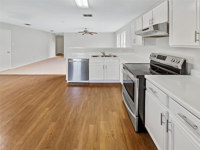 kitchen with white cabinetry, sink, ceiling fan, appliances with stainless steel finishes, and light wood-type flooring