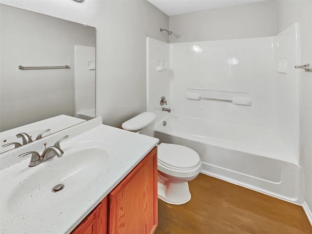 full bathroom with hardwood / wood-style floors, vanity, tub / shower combination, and toilet