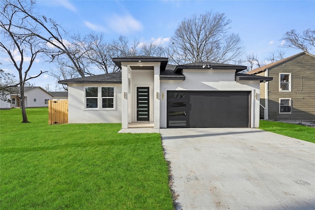 prairie-style home featuring a garage and a front yard