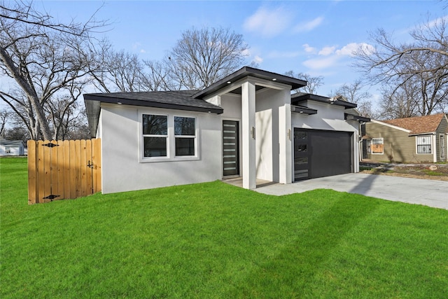 view of front of property featuring a garage and a front lawn