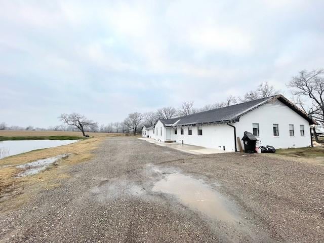 view of side of home featuring a water view