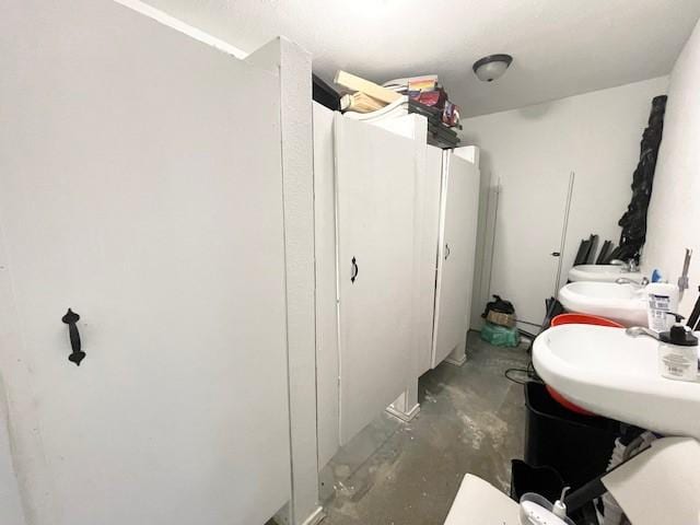 bathroom with sink and concrete floors