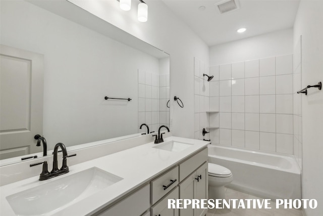 full bathroom featuring tile patterned floors, vanity, toilet, and tiled shower / bath