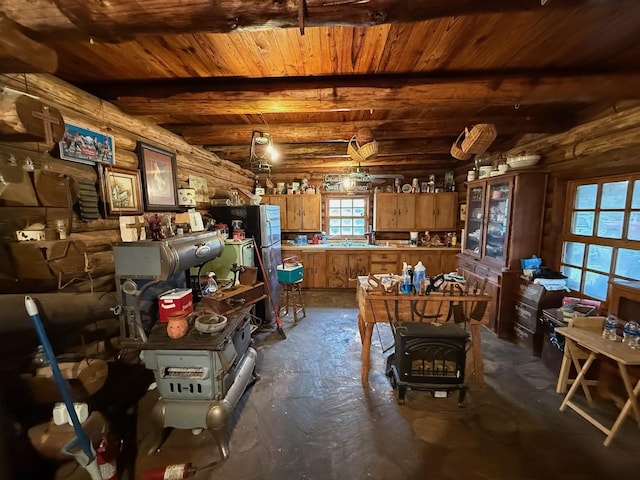 interior space featuring beamed ceiling, log walls, and wood ceiling