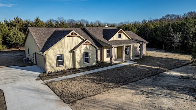 view of front of house featuring a garage and cooling unit