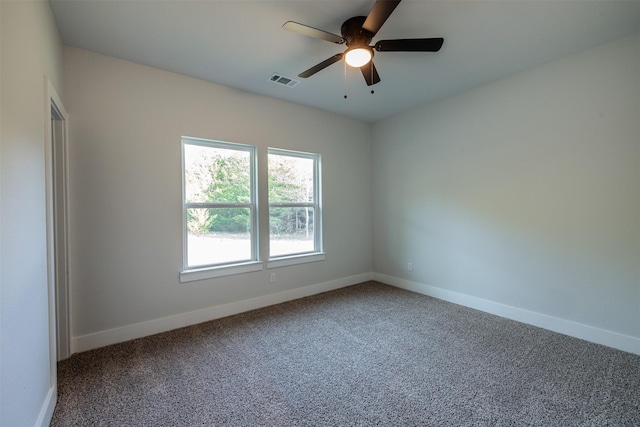 carpeted spare room with ceiling fan