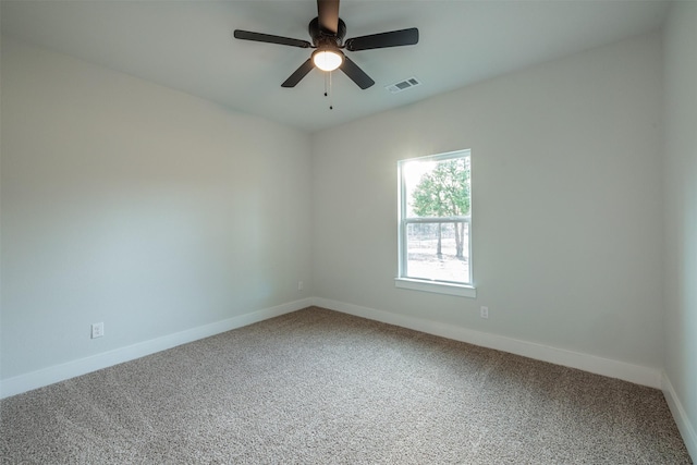 carpeted spare room with ceiling fan