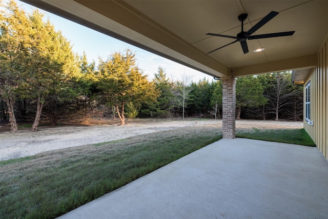 view of yard featuring ceiling fan and a patio