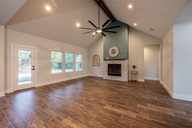 unfurnished living room with lofted ceiling with beams, a fireplace, ceiling fan, and dark wood-type flooring