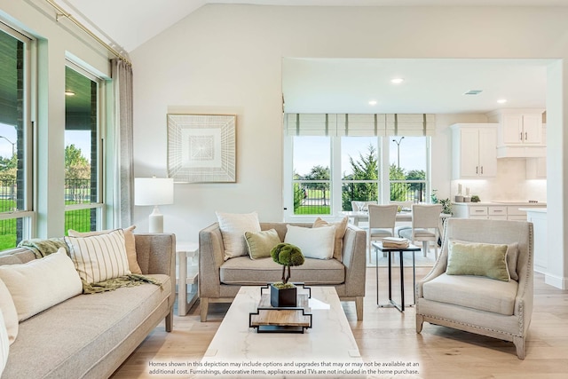 living room featuring light wood-type flooring and vaulted ceiling