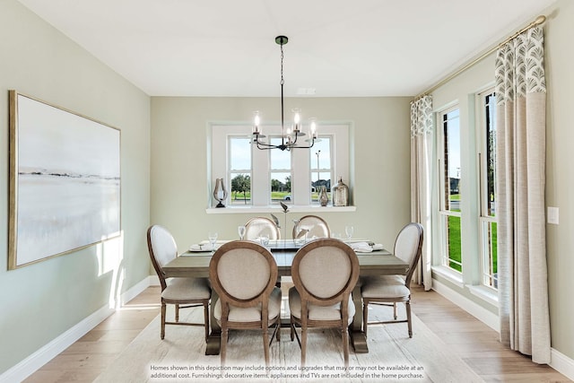 dining area featuring light hardwood / wood-style flooring and a notable chandelier