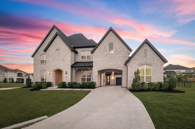 french country home featuring a yard