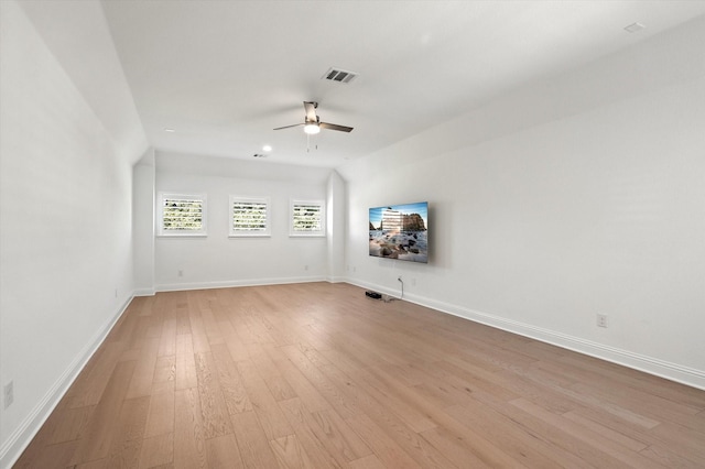 empty room featuring ceiling fan, light hardwood / wood-style floors, and lofted ceiling