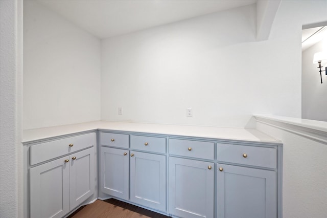 clothes washing area with dark wood-type flooring