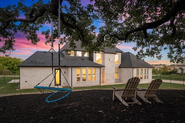 view of back house at dusk