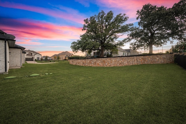 view of yard at dusk