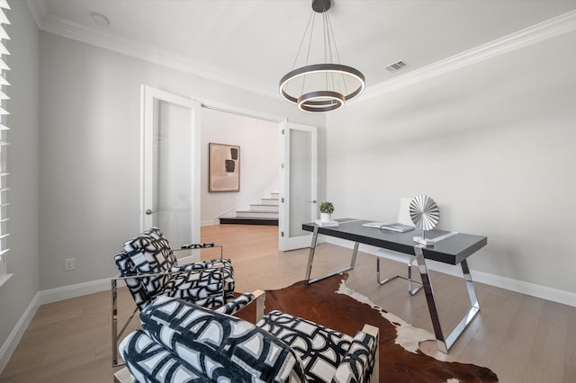 home office featuring wood-type flooring, ornamental molding, and french doors